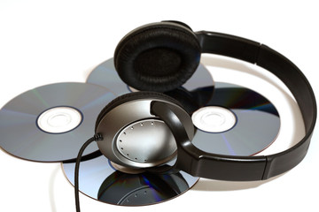 stereo head phones with CD's on a white background