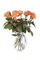 Obraz premium red roses in a glass vase isolated on white