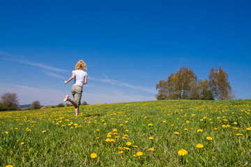 Fototapeta premium young female having fun on flowery meadow