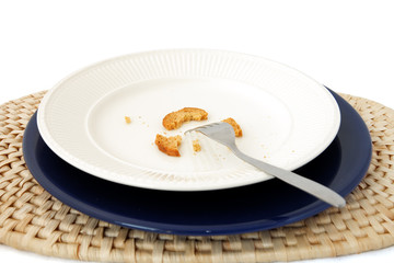 plate, blue under-plate & raffia place-mat. fork & cracked toast