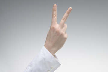 Woman's hand showing Victory symbol