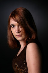 Naklejka premium beautiful teenage girl with auburn hair obscuring one eye