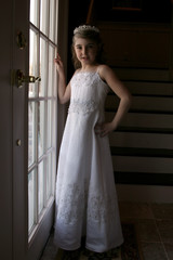 Fototapeta premium pretty young girl in white bridesmaid's dress and tiarra