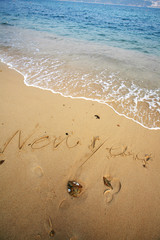 happy new year on beach with wave