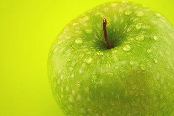 apple with drops on a green background