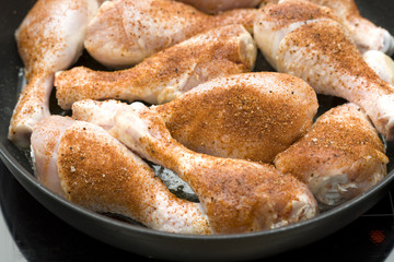 Frying chicken legs with pepper.