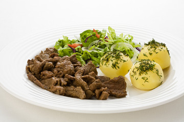 Grilled meat with boiled potatoes, sauce and vegetable salad