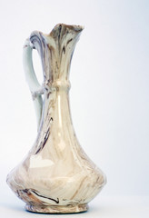 Ceramic earthenware vase with a decorative handle, fluted spout.