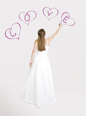 Bride drawing hearts on the wall