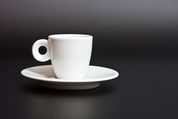white cup of coffee on black background