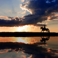 Horseback riding on coastline on sunset
