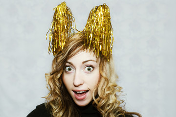 blonde crazy girl with party golden tinsel horns