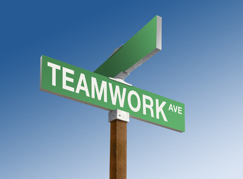 Green street sign with "Teamwork" printed on it