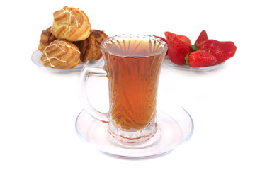 tea cup and eclairs with strawberry