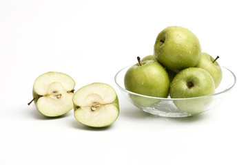 stack of green apples on glass plate