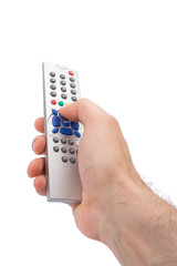 Hand holding a TV remote control isolated on white.