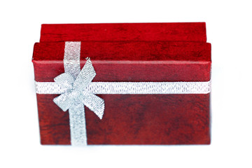 Red gift box with silver ribbon isolated on white background