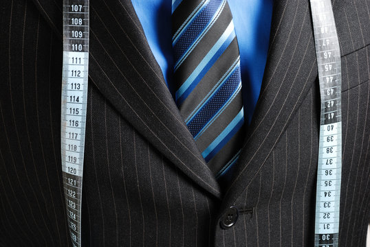 Business man with tape measure
