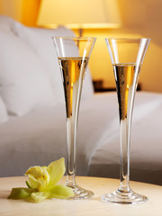 Romantic evening in an interior with a glass of a champagne.