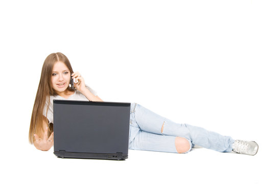 Talking pretty girl with phone and laptop