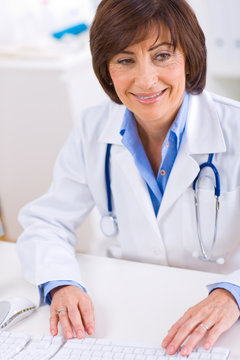 Female doctor working at office