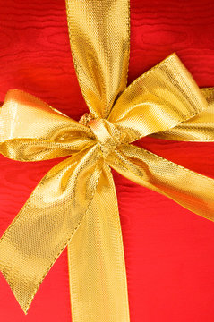 Fototapeta Close up of red gift box with gold bow