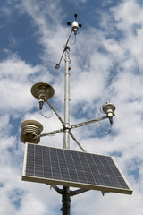 Solar battery and meteorological devices on sky background