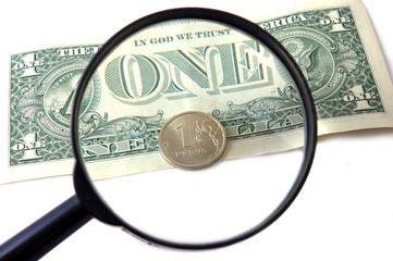 Bill 1 dollar and coin 1 rouble under magnifying glass