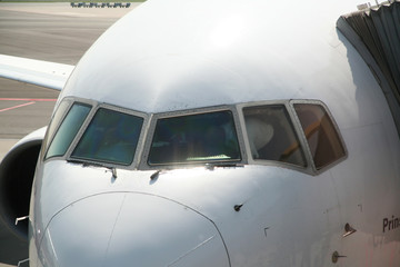 Cockpit of airplane at gate while pilots prepare departure