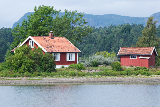 Two red houses by the sea