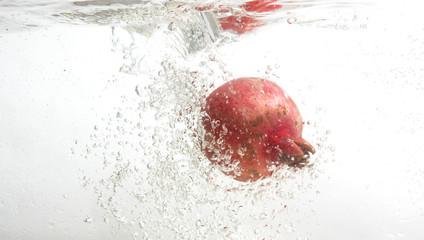 Fresh pomegranate in water.