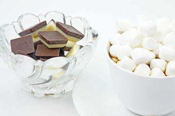 Dark chocolate with marshmallows heaped on top with sweets.