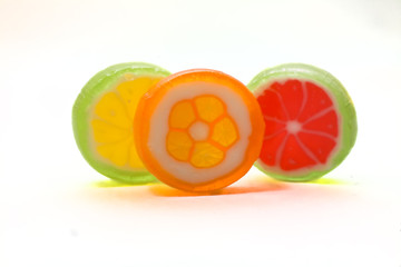 Three multi-coloured sugar candies
