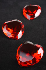 Heart shaped ruby jewels over black velvet