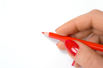 Red pencil in woman hand