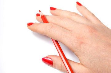 Red pencil in woman hand