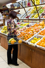 Woman shopping for fruits at grocery store