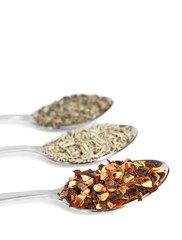 Spoonful of herbs isolated on white background
