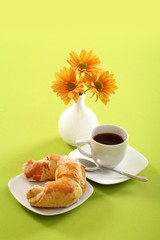 Breakfast concept with coffee and croissant