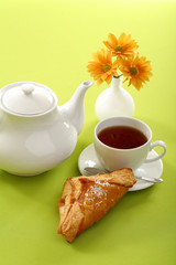 Breakfast concept with coffee and croissant