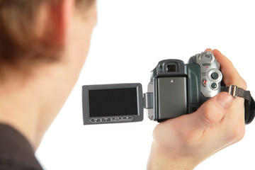 Man with camcorder in hand from back