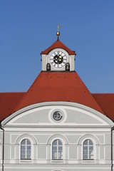 Fototapeta premium Detail of a castle. Red tiled roof with clock tower.