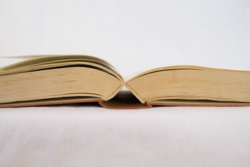 opened vintage book with white background