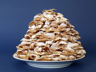 Plate full of traditional Polish sweet crispy biscuits - Faworki