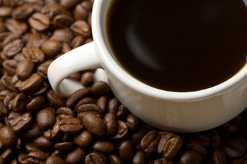 white cup of coffee and coffee beans