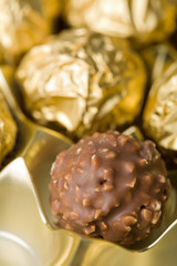 chocolate candies over golden background