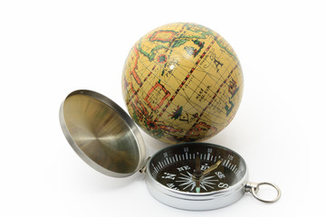 Modern compass and ancient globe isolated on white