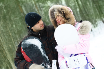 young couple with snowboards