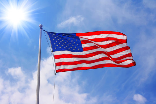 American flag against blue sunny sky