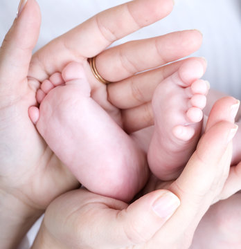 Mother holding her child's feet